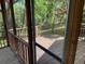 A screened in porch area overlooking the backyard with a wood railing at 1150 Orchard Way, Roswell, GA 30075