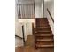 Staircase featuring hardwood steps, wood railing, and access to other rooms at 1150 Orchard Way, Roswell, GA 30075