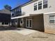 Back exterior featuring a remote controlled retractable awning and a comfortable patio at 13015 Fox Rd, Alpharetta, GA 30005
