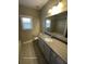 Bathroom featuring modern vanity, ample counter space and tub at 13015 Fox Rd, Alpharetta, GA 30005