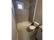 Full bathroom with tiled walls, white fixtures and tiled floors for a clean, modern look at 13015 Fox Rd, Alpharetta, GA 30005