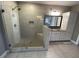 Bright bathroom offers a glass enclosed shower and a vanity with drawers and overhead cabinet at 13015 Fox Rd, Alpharetta, GA 30005