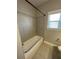 Bathroom featuring modern shower with light tile and glass door at 13015 Fox Rd, Alpharetta, GA 30005