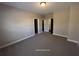 Bedroom with carpeted floor, neutral wall color, and multiple doors that enhance the room's appeal at 13015 Fox Rd, Alpharetta, GA 30005