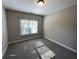 Bedroom with carpet, bright window, and neutral walls perfect for creating a peaceful retreat at 13015 Fox Rd, Alpharetta, GA 30005