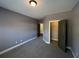 Bedroom featuring neutral colors, plush carpet, closet, and access to other rooms at 13015 Fox Rd, Alpharetta, GA 30005