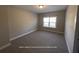Bedroom with carpeted floor, neutral wall color, and a window that provide a relaxing atmosphere at 13015 Fox Rd, Alpharetta, GA 30005