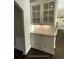 Butler's pantry featuring granite countertops, subway tile backsplash, and display shelving at 13015 Fox Rd, Alpharetta, GA 30005