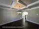 Formal dining room featuring decorative ceiling beams and an elegant chandelier at 13015 Fox Rd, Alpharetta, GA 30005