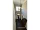 Welcoming foyer featuring high ceilings, decorative chandelier, and a large window allowing natural light at 13015 Fox Rd, Alpharetta, GA 30005