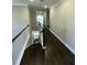 Hallway with wood floors, white trim, and natural light leading to the bedrooms and living spaces at 13015 Fox Rd, Alpharetta, GA 30005