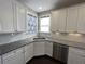 Close-up of a kitchen with white cabinets, granite counters, stainless steel appliances, and subway tile backsplash at 13015 Fox Rd, Alpharetta, GA 30005
