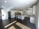 Spacious kitchen boasts white cabinets, stainless steel appliances, granite counters, and a large island at 13015 Fox Rd, Alpharetta, GA 30005