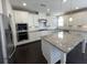 Bright kitchen with white cabinets, granite countertops, stainless steel appliances, and a kitchen island at 13015 Fox Rd, Alpharetta, GA 30005