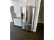 Stainless steel refrigerator stands next to white cabinets and granite counters at 13015 Fox Rd, Alpharetta, GA 30005