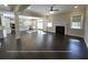Open-concept living room and kitchen featuring hardwood floors, a fireplace, and plenty of space at 13015 Fox Rd, Alpharetta, GA 30005