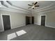 Spacious main bedroom with three door entry ways and a tray ceiling at 13015 Fox Rd, Alpharetta, GA 30005