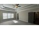 Main bedroom featuring tray ceiling and two closets at 13015 Fox Rd, Alpharetta, GA 30005