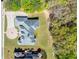 Aerial view of a stately home with a circular driveway and lush, wooded surroundings at 1660 Norris Landing Dr, Snellville, GA 30039