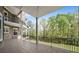 Large back porch overlooks a beautiful yard with mature trees and a private setting with metal railing at 1660 Norris Landing Dr, Snellville, GA 30039