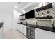 Stylish bar area with geometric tile backsplash, wine racks, and cooler for the discerning entertainer at 1660 Norris Landing Dr, Snellville, GA 30039