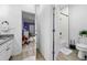 Bright bathroom with granite counters, white cabinets, and a glimpse into the purple room at 1660 Norris Landing Dr, Snellville, GA 30039