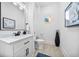 Modern powder room with white marble countertop and decorative circular window at 1660 Norris Landing Dr, Snellville, GA 30039