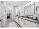 Bright bathroom with granite countertop vanity, double sinks, and modern fixtures at 1660 Norris Landing Dr, Snellville, GA 30039