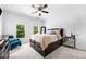 Cozy bedroom with plush carpet, a ceiling fan, and a large window with a view of the outdoors at 1660 Norris Landing Dr, Snellville, GA 30039