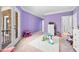 Lavender-colored bedroom with plush carpet and french doors that lead to a balcony at 1660 Norris Landing Dr, Snellville, GA 30039