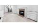 A versatile bonus room features a fireplace, neutral colors, and staircase, blending comfort and style seamlessly at 1660 Norris Landing Dr, Snellville, GA 30039