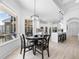 Charming breakfast nook featuring a stylish chandelier, modern windows, and access to a bright, modern kitchen at 1660 Norris Landing Dr, Snellville, GA 30039