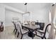 A dining room with an elegant table, decorative light fixture, and a neutral color scheme for a sophisticated ambiance at 1660 Norris Landing Dr, Snellville, GA 30039