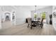 Bright dining room with hardwood floors, modern chandelier, and large windows at 1660 Norris Landing Dr, Snellville, GA 30039