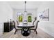 Dining room featuring elegant chairs, light fixture, light wood-look floors, and lots of natural light at 1660 Norris Landing Dr, Snellville, GA 30039