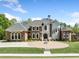 Beautiful home showcasing impeccable landscaping, circular driveway, and elegant architectural design at 1660 Norris Landing Dr, Snellville, GA 30039
