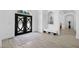 Light-filled foyer with arched doorway, decorative double-doors and light wood-look floors at 1660 Norris Landing Dr, Snellville, GA 30039