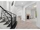 Elegant foyer features a wrought iron staircase, light hardwood floors, and an arched doorway leading to the living room at 1660 Norris Landing Dr, Snellville, GA 30039