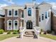 A European-style home featuring double front doors, and beautiful manicured landscaping with stone and stucco accents at 1660 Norris Landing Dr, Snellville, GA 30039