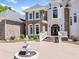 Elegant home featuring a circular driveway with fountain, stone accents, and a grand entrance at 1660 Norris Landing Dr, Snellville, GA 30039