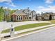 Beautiful home with a circular driveway, lush lawn, and manicured landscaping at 1660 Norris Landing Dr, Snellville, GA 30039