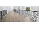 Upstairs hallway featuring wrought iron railings and light hardwood floors overlooking the entry way at 1660 Norris Landing Dr, Snellville, GA 30039