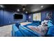 Cozy home theater featuring a blue sectional sofa and large screen for immersive entertainment at 1660 Norris Landing Dr, Snellville, GA 30039