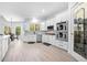 Gourmet kitchen featuring stainless appliances, sleek white cabinetry, herringbone backsplash, and a pantry at 1660 Norris Landing Dr, Snellville, GA 30039