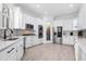 Modern kitchen featuring white cabinets, stainless steel appliances, and a stylish herringbone backsplash at 1660 Norris Landing Dr, Snellville, GA 30039