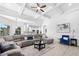 Bright living room showcasing a large sectional sofa, stylish decor, and a seamless transition to the modern kitchen at 1660 Norris Landing Dr, Snellville, GA 30039