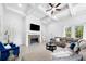 Spacious living room with a stone fireplace, coffered ceilings, and a large sectional couch perfect for relaxing at 1660 Norris Landing Dr, Snellville, GA 30039