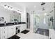 A sleek bathroom showcasing double sinks, a glass shower, modern fixtures, and plenty of vanity space at 1660 Norris Landing Dr, Snellville, GA 30039