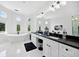 A luxurious bathroom boasting a soaking tub, dual sinks, modern fixtures, circular windows, and lots of natural light at 1660 Norris Landing Dr, Snellville, GA 30039