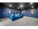 Stylish media room with a large, comfortable blue sectional and a dark ceiling for the ultimate viewing experience at 1660 Norris Landing Dr, Snellville, GA 30039